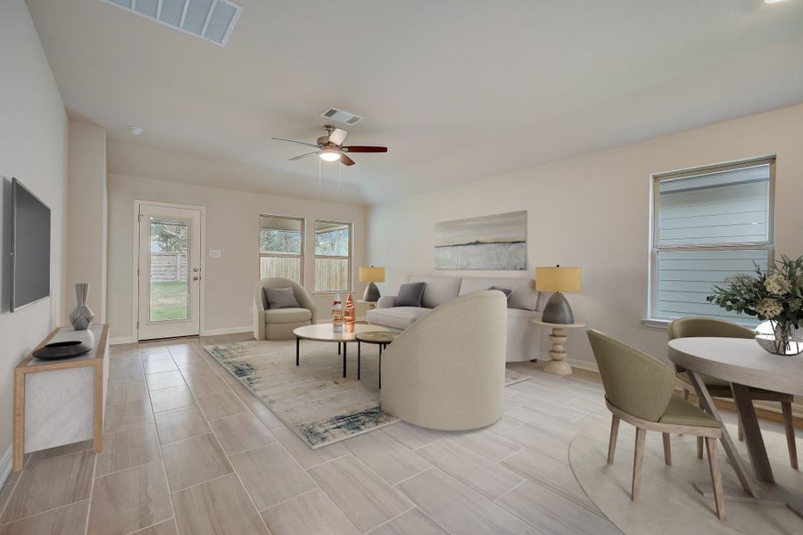 Virtually staged dining room and living room in the Oleander floorplan at a Meritage Homes community.