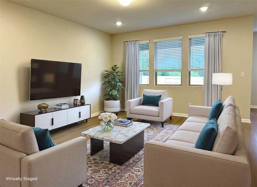 Living room with LVP floors, baseboards, and recessed lighting