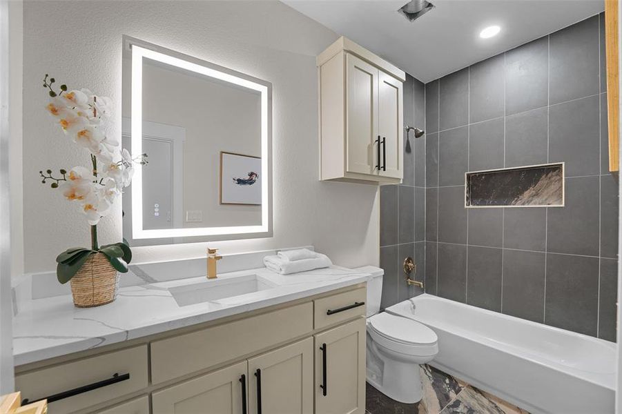 Contemporary bathroom featuring an illuminated vanity mirror Contemporary bathroom featuring an illuminated vanity mirror