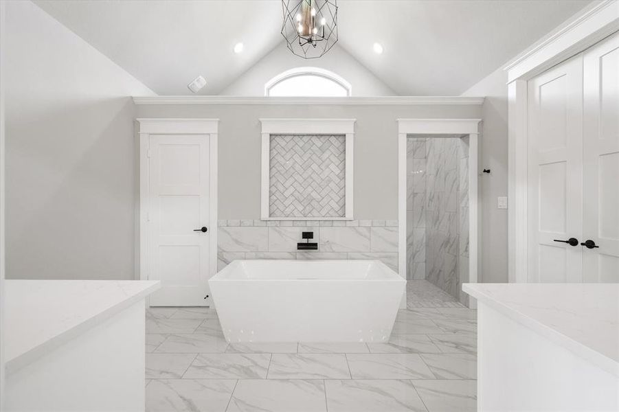 Freestanding soaking tub with a wall-mounted matte black faucet