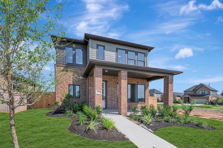 Front exterior of a new home in Sienna - Landmark Row Collection, Missouri City, TX, highlighting curb appeal (Image 27). Front exterior of a new home in Sienna - Landmark Row Collection, Missouri City, TX, highlighting curb appeal (Image 27).