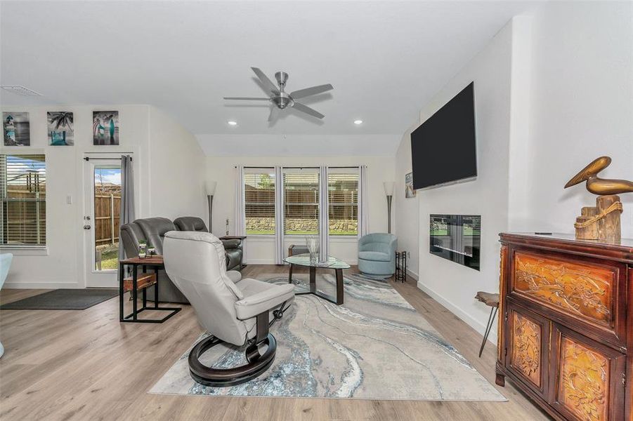 Living room with light wood-type flooring and ceiling fan