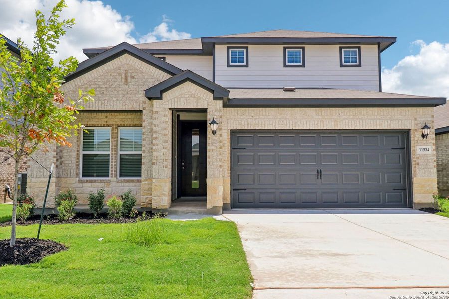 Front exterior of a new home in Sagebrooke - Premier Series, San Antonio, TX, highlighting curb appeal (Image 26). Front exterior of a new home in Sagebrooke - Premier Series, San Antonio, TX, highlighting curb appeal (Image 26).