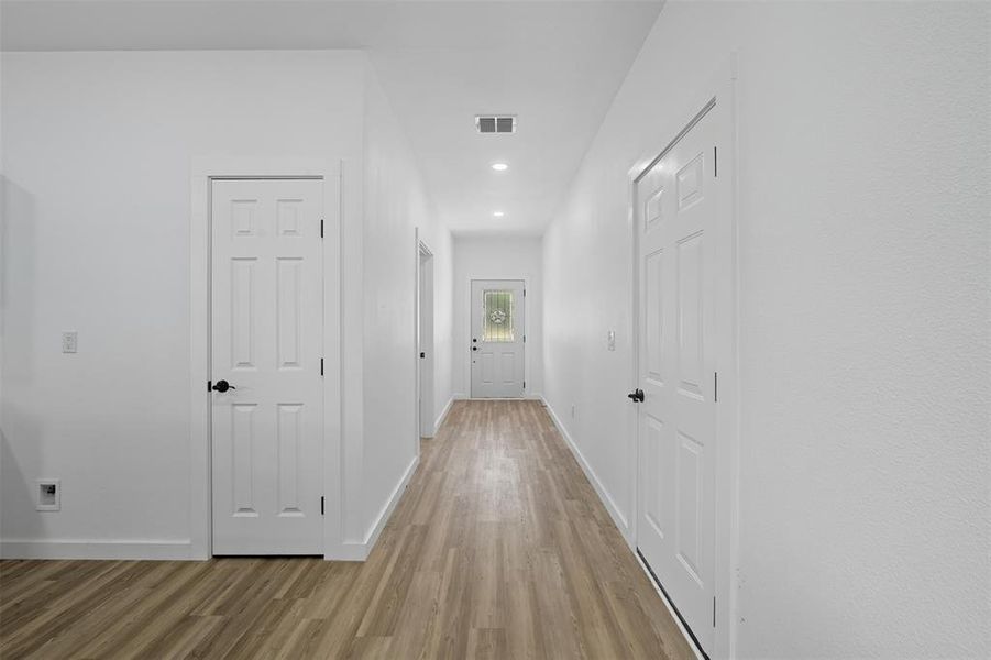 Corridor with light wood finished floors and recessed lighting Corridor with light wood finished floors and recessed lighting