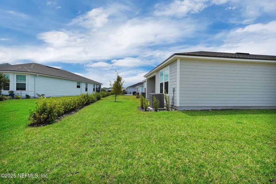 Front exterior of a new home in Summer Bay at Grand Oaks, St. Augustine, FL, highlighting curb appeal (Image 16).