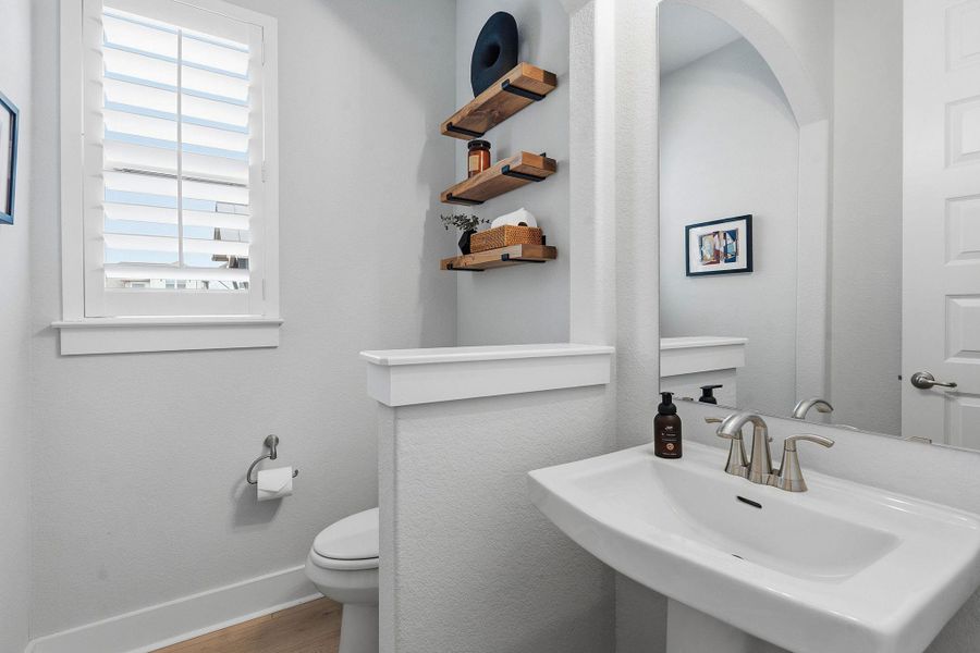 Bathroom with toilet and wood finished floors