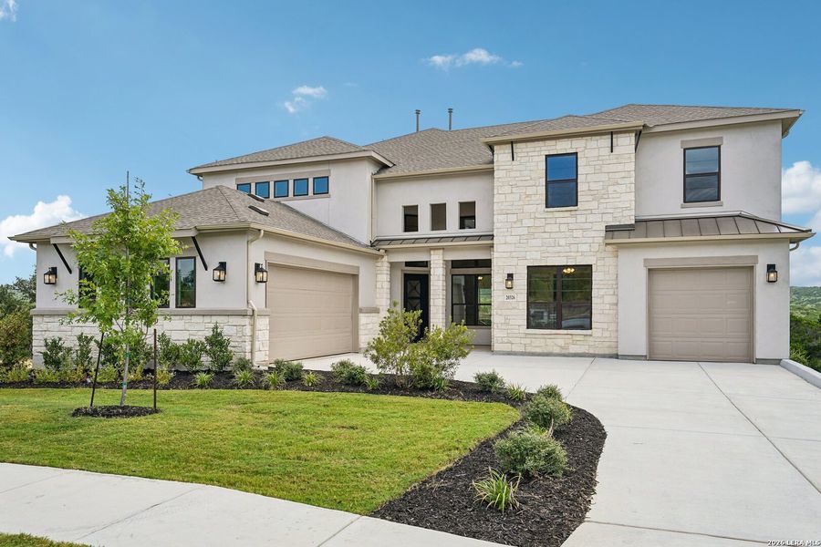 Front exterior of a new home in Verandas at the Rim, San Antonio, TX, highlighting curb appeal (Image 1). Front exterior of a new home in Verandas at the Rim, San Antonio, TX, highlighting curb appeal (Image 1).