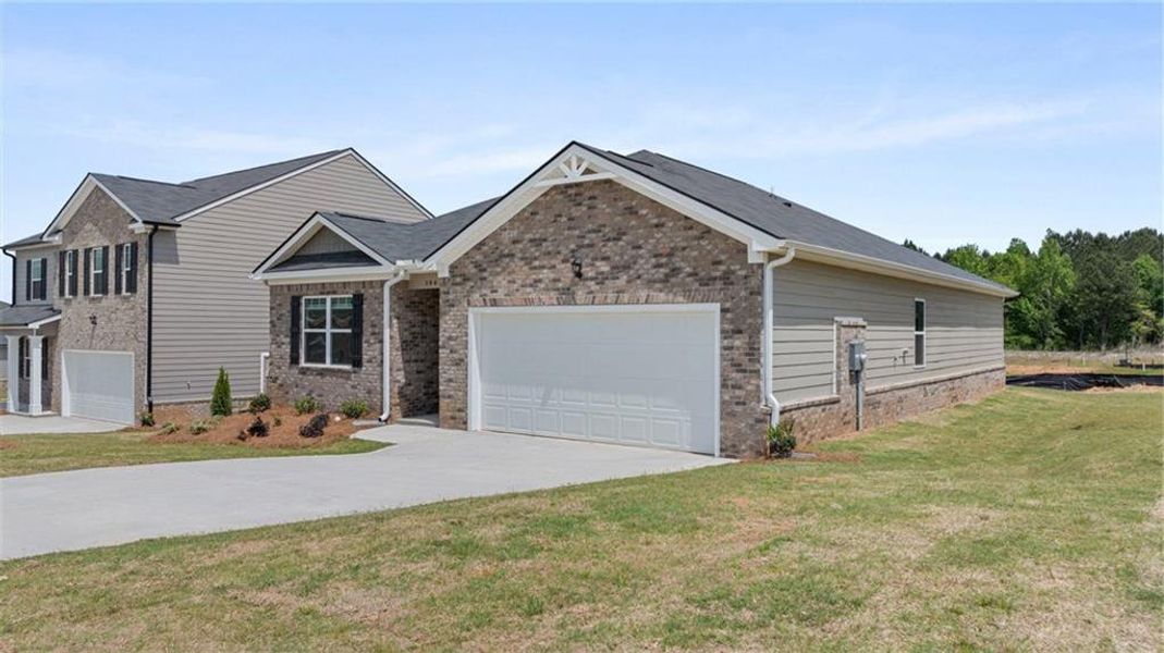 Front exterior of a new home in The Reserve at Calcutta, Stockbridge, GA, highlighting curb appeal (Image 2). Front exterior of a new home in The Reserve at Calcutta, Stockbridge, GA, highlighting curb appeal (Image 2).