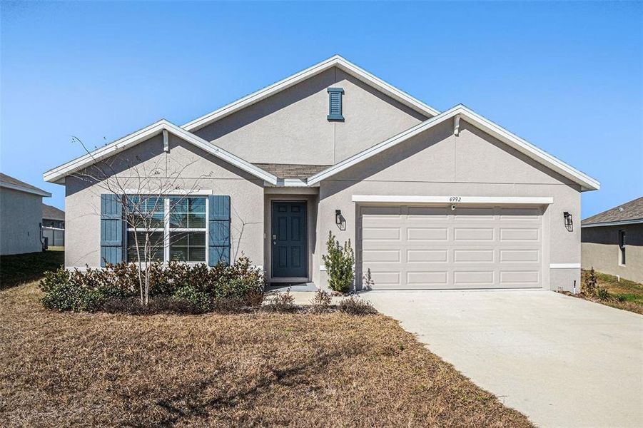 Front exterior of a new home in Fairways at Twisted Oaks, Beverly Hills, FL, highlighting curb appeal (Image 21).