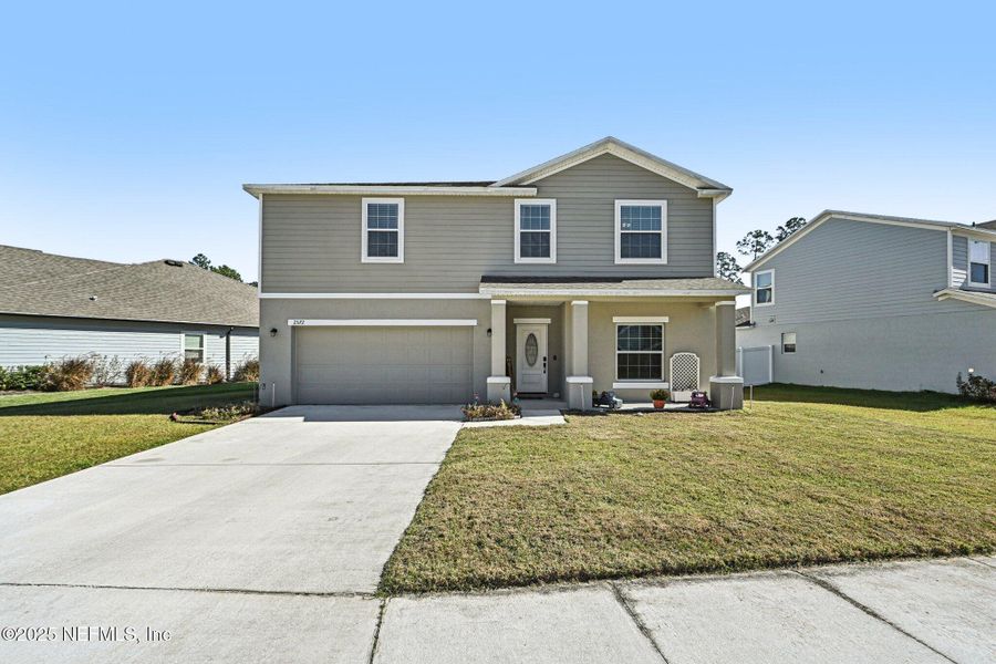 Front exterior of a new home in Village Park, Green Cove Springs, FL, highlighting curb appeal (Image 24).