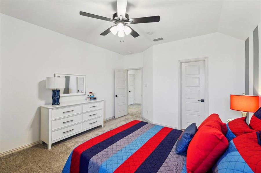 Bedroom featuring lofted ceiling, light carpet, and ceiling fan