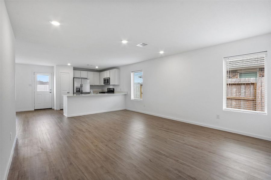 Open Floor Plan with tall ceilings Family Room open to the Kitchen.