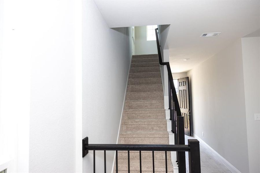 Stairs featuring baseboards and wood finished floors Stairs featuring baseboards and wood finished floors