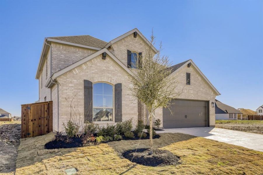 Front exterior of a new home in Wellington, Haslet, TX, highlighting curb appeal (Image 2).
