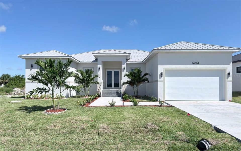 Front exterior of a new home in , Port Charlotte, FL, highlighting curb appeal (Image 1).