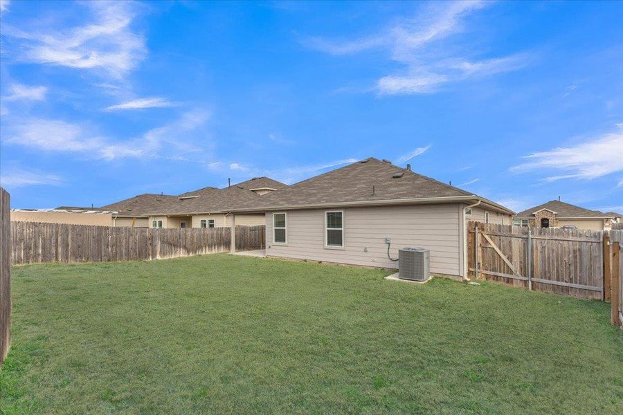 Back of property with a fenced backyard