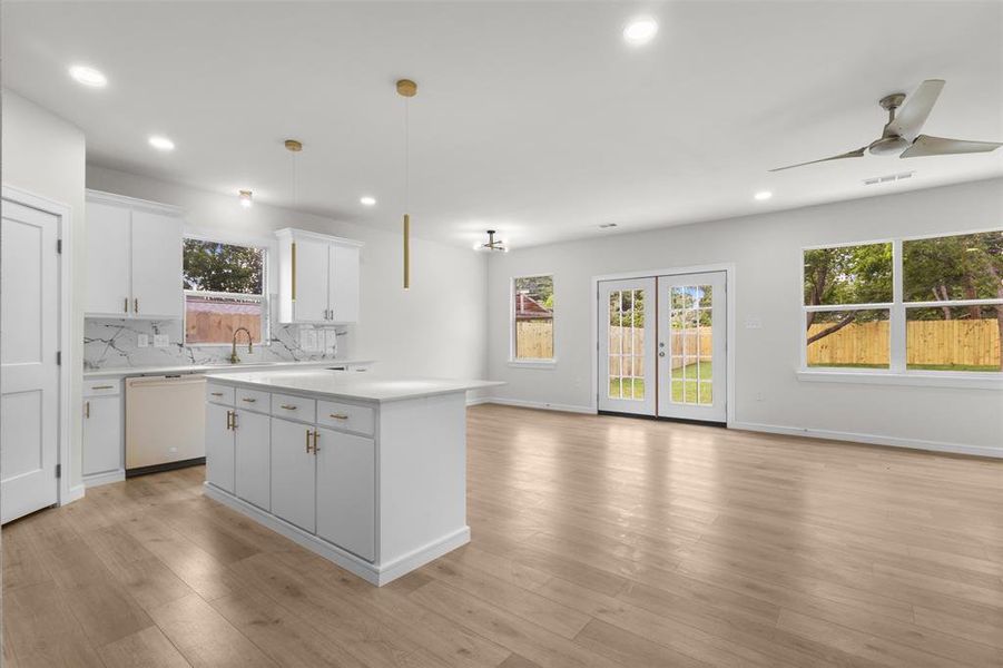 Open-concept living space featuring wood-finish flooring, recessed lighting, and a modern ceiling fan