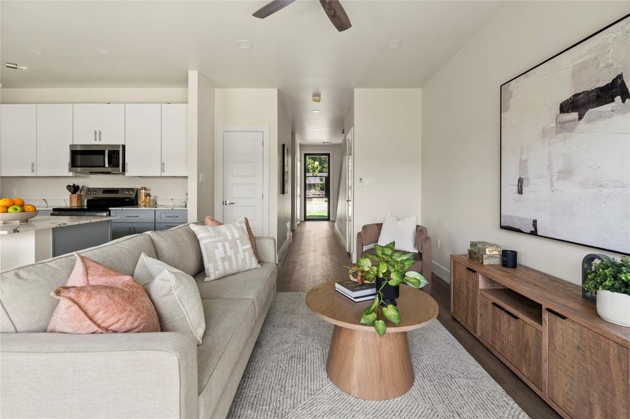 An open-concept living space integrates a well-appointed kitchen with stainless steel appliances and ample cabinetry.