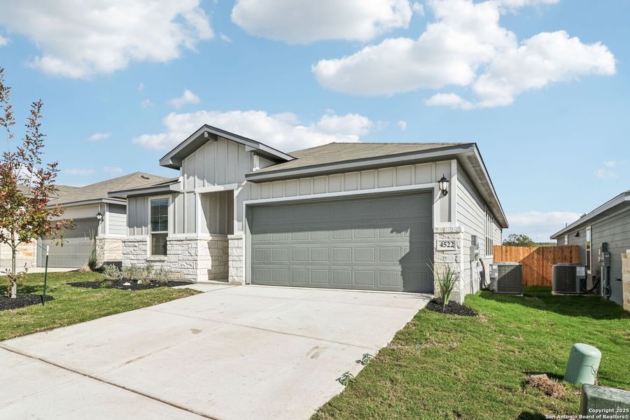 Front exterior of a new home in Remington Ranch, San Antonio, TX, highlighting curb appeal (Image 18). Front exterior of a new home in Remington Ranch, San Antonio, TX, highlighting curb appeal (Image 18).