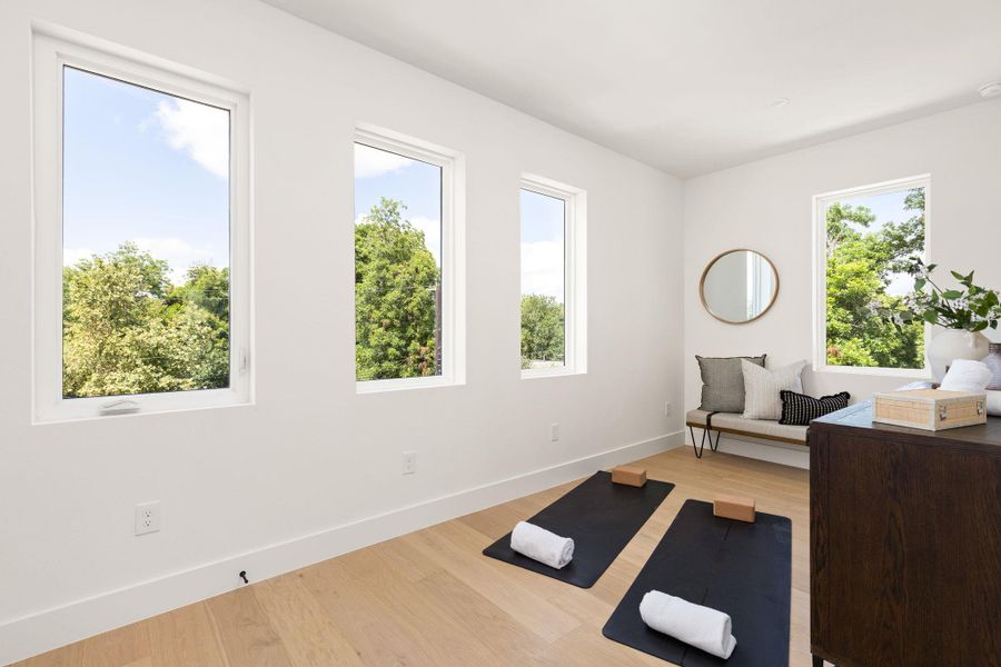 Sun-filled room with wood flooring offers tranquil space, ideal for relaxation or exercise. Sun-filled room with wood flooring offers tranquil space, ideal for relaxation or exercise.