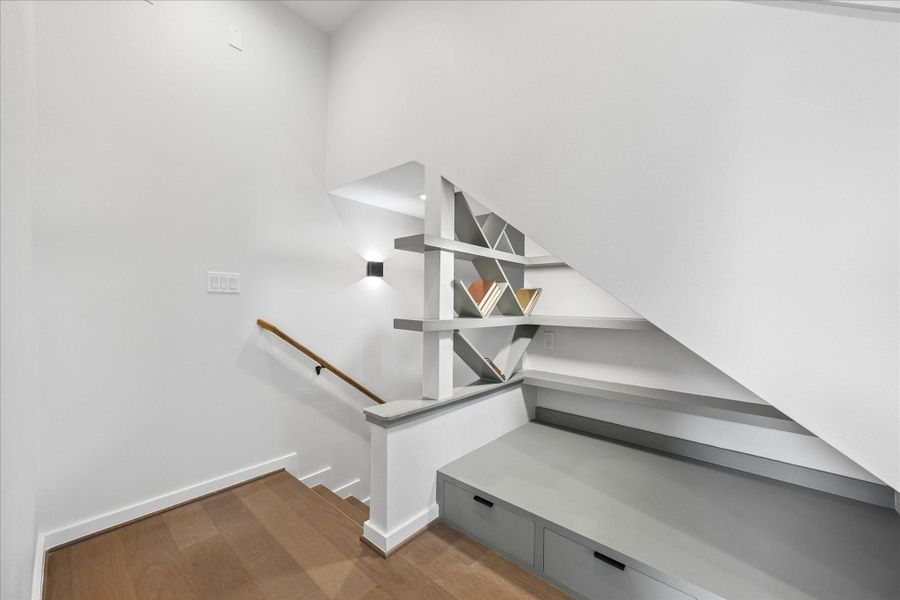 Custom built in shelving with integrated bench seating and storage creates a stylish, multifunctional architectural feature. Custom built in shelving with integrated bench seating and storage creates a stylish, multifunctional architectural feature.