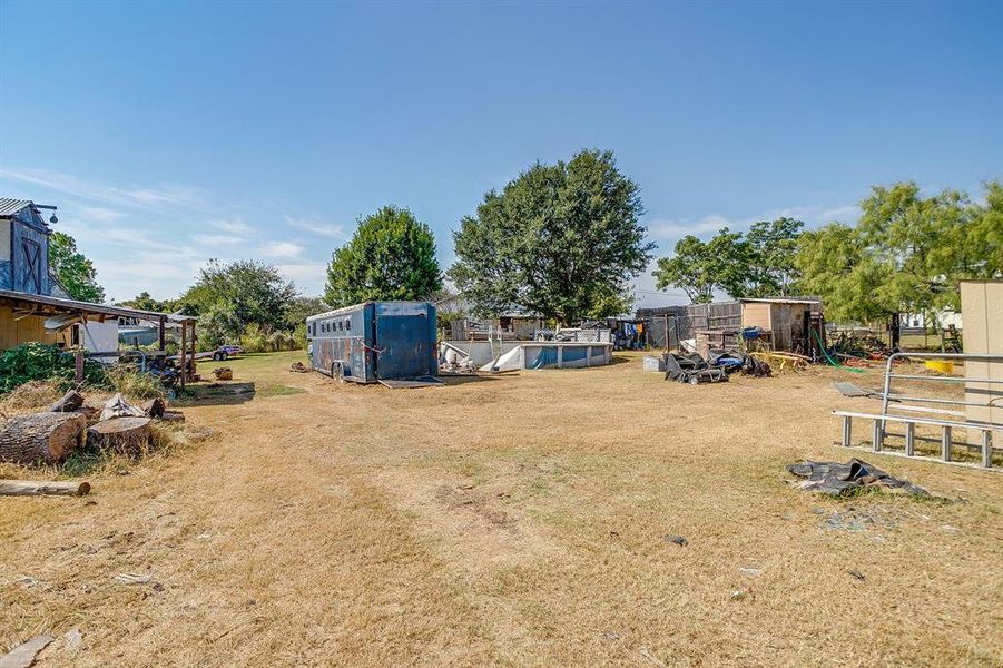 View of grassy yard featuring an outbuilding View of grassy yard featuring an outbuilding