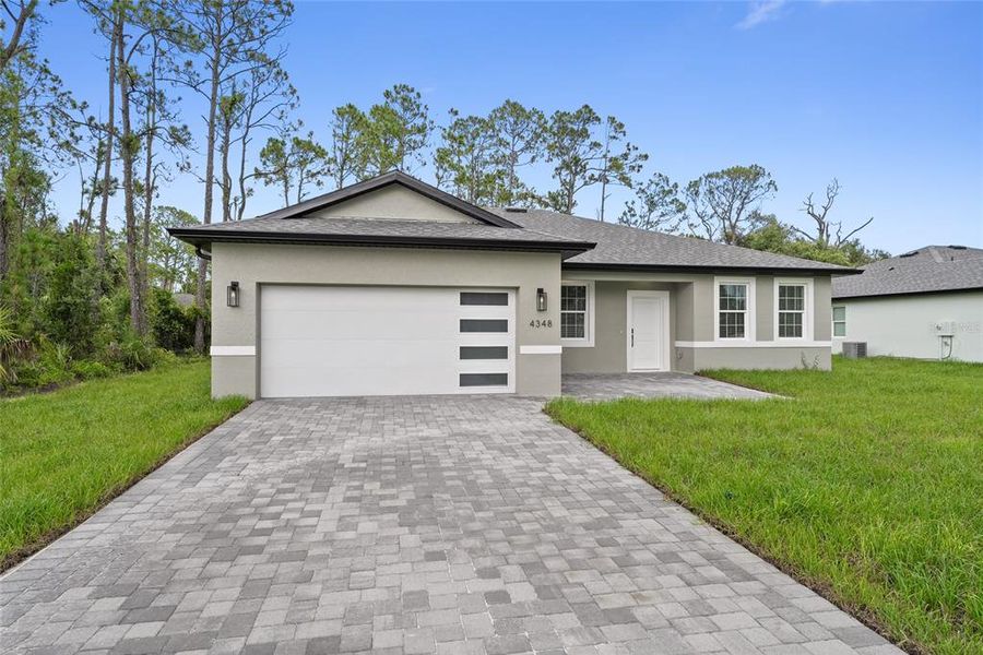 Front exterior of a new home in , North Port, FL, highlighting curb appeal (Image 17). Front exterior of a new home in , North Port, FL, highlighting curb appeal (Image 17).