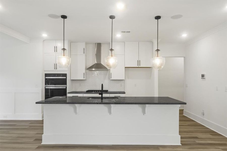 Clean lines and dark quartz countertops define thi