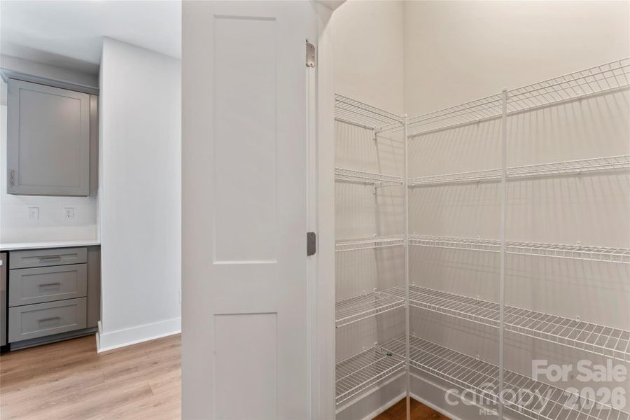 Spacious double-door pantry provides ample room for groceries, small appliances, and extra storage. Spacious double-door pantry provides ample room for groceries, small appliances, and extra storage.