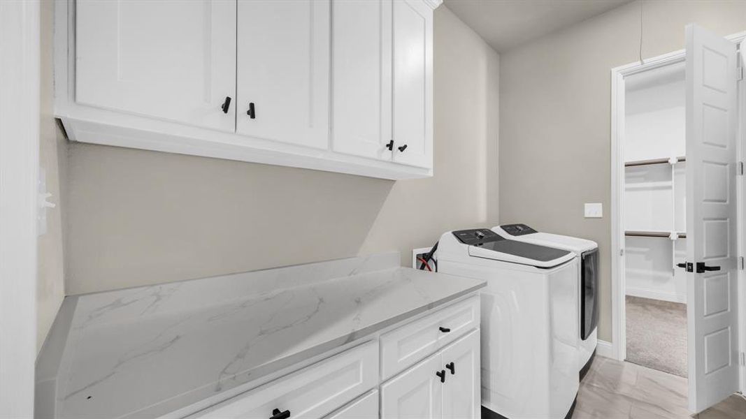 Laundry room comes with a matching washer and dryer set, along with plenty of counter space and cabinetry to organize your laundry and store cleaning supplies.