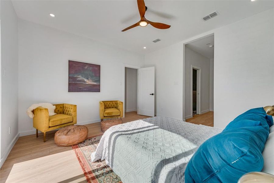 Bedroom with ceiling fan and light wood-type flooring