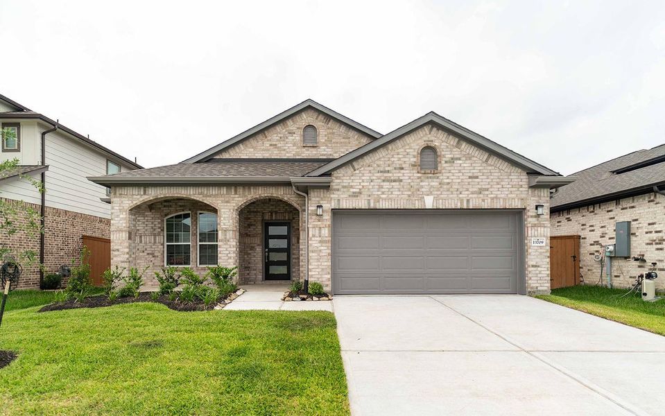 Front exterior of a new home in Lago Mar, Texas City, TX, highlighting curb appeal (Image 1).