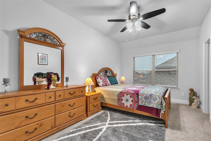 Bedroom featuring carpet, a ceiling fan, and baseboards