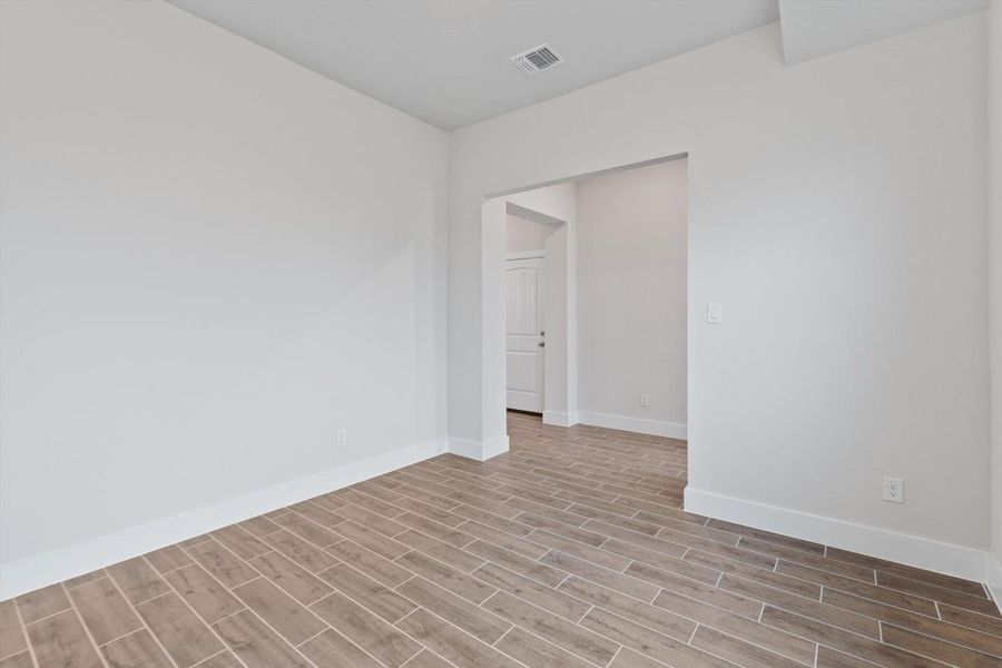 A well-lit room showcasing durable tile flooring and a neutral color palette, ideal for personalization. A well-lit room showcasing durable tile flooring and a neutral color palette, ideal for personalization.