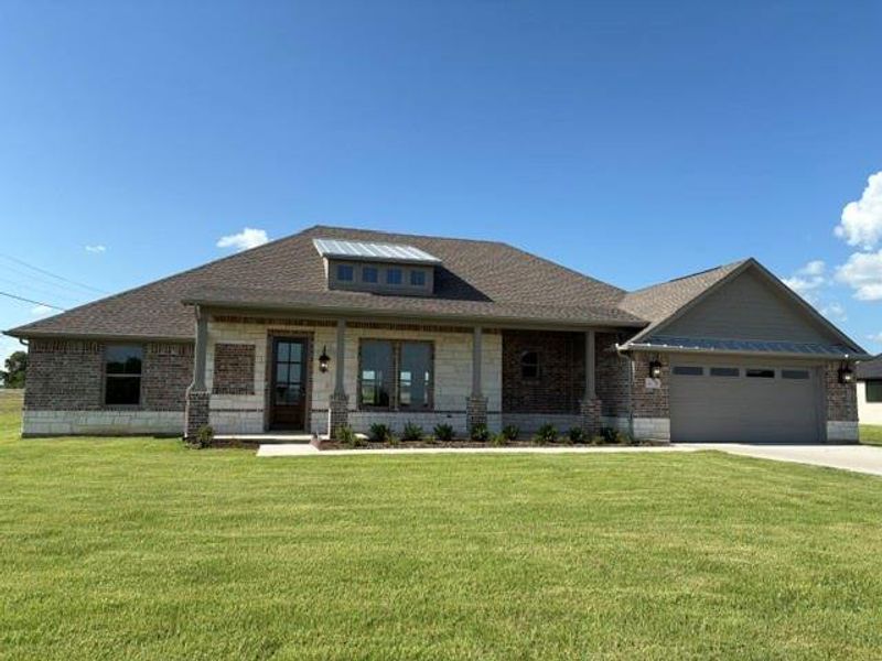 Front exterior of a new home in , Van Alstyne, TX, highlighting curb appeal (Image 26). Front exterior of a new home in , Van Alstyne, TX, highlighting curb appeal (Image 26).