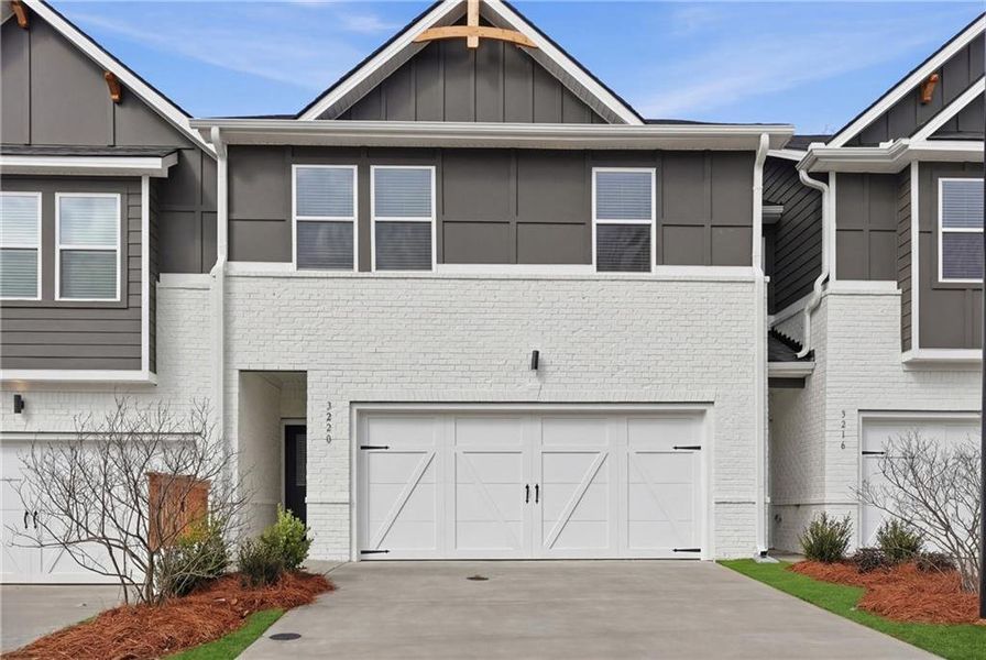 Front exterior of a new home in Concord Oaks, Powder Springs, GA, highlighting curb appeal (Image 1). Front exterior of a new home in Concord Oaks, Powder Springs, GA, highlighting curb appeal (Image 1).