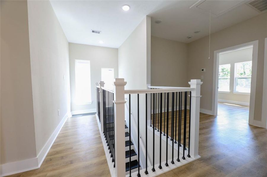 The 2nd floor is very inviting w/ warm wood floors, large windows, a sitting area nook, laundry room & all bedrooms/full baths.