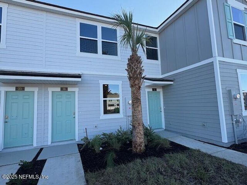 Exterior details and patio area of a home in Cordera Townhomes, St. Augustine (Image 1).