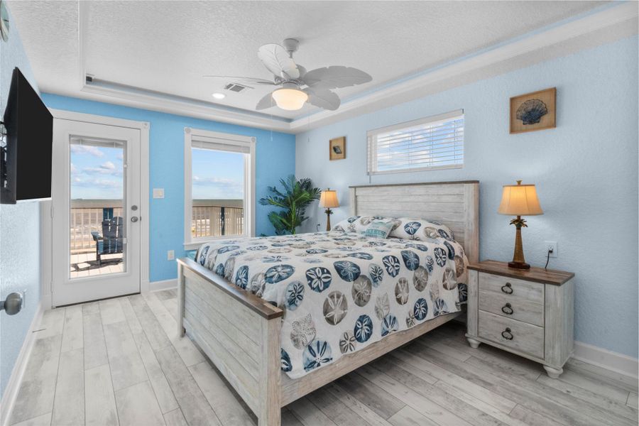 The beachfront view from the master bedroom windows is AMAZING!!! Master bedroom. Direct balcony access from bedroom.