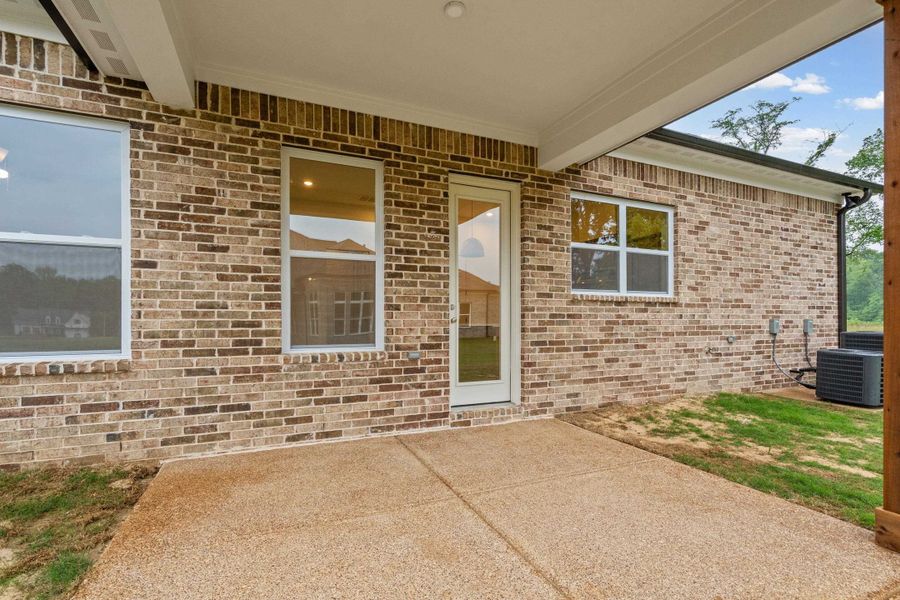 Expansive concrete patio under a covered porch Expansive concrete patio under a covered porch