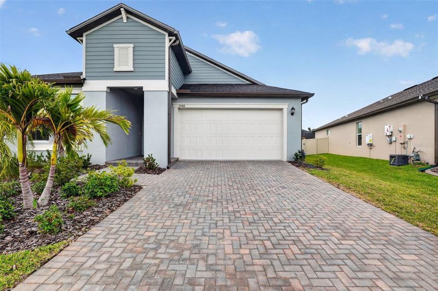 Front exterior of a new home in Stonegate Preserve, Palmetto, FL, highlighting curb appeal (Image 2).