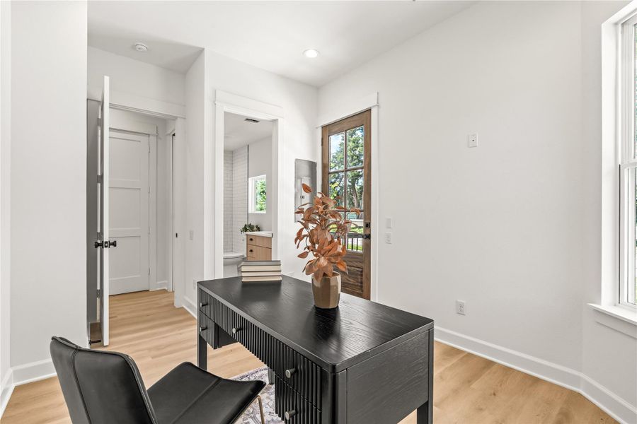 Alternate elevation — first-floor bedroom with glass back door and natural light throughout Alternate elevation — first-floor bedroom with glass back door and natural light throughout