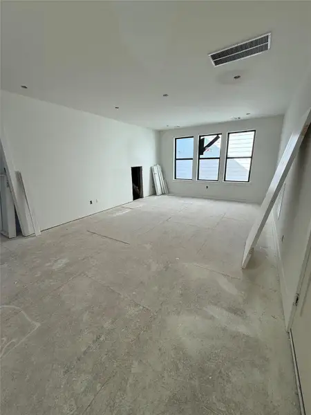 The third floor offers a game room with three large windows, providing abundant natural light. Ideal for a media room, home office, or personal gym, this open area reflects the home’s modern design - with clean lines, neutral finishes, and endless potential. The third floor offers a game room with three large windows, providing abundant natural light. Ideal for a media room, home office, or personal gym, this open area reflects the home’s modern design - with clean lines, neutral finishes, and endless potential.