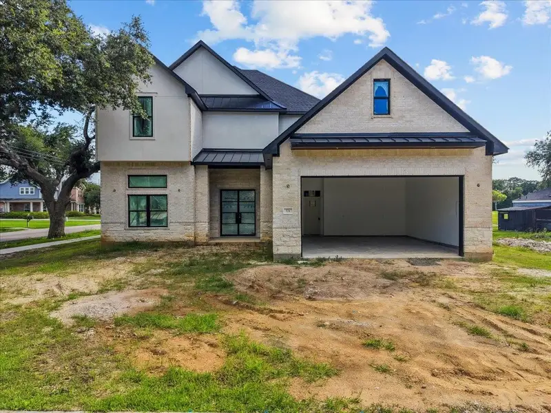 Front exterior of a new home in , League City, TX, highlighting curb appeal (Image 1). Front exterior of a new home in , League City, TX, highlighting curb appeal (Image 1).