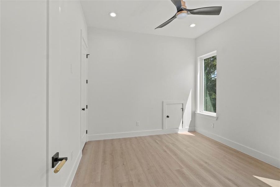 Unfurnished room featuring ceiling fan, light hardwood / wood-style flooring, and a healthy amount of sunlight