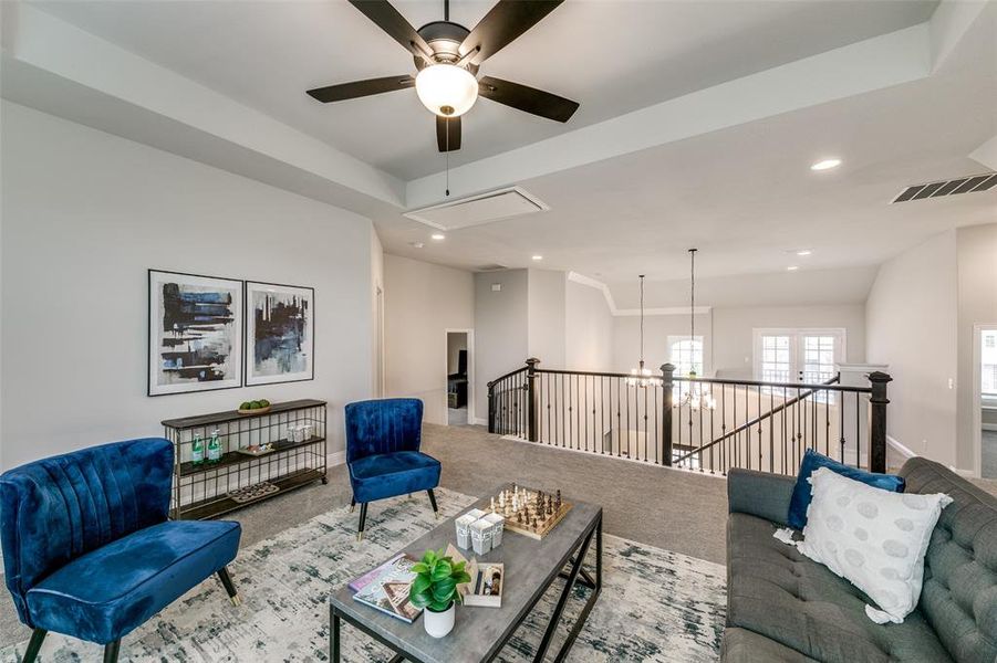 Upstairs flex space  featuring carpet and ceiling fan.