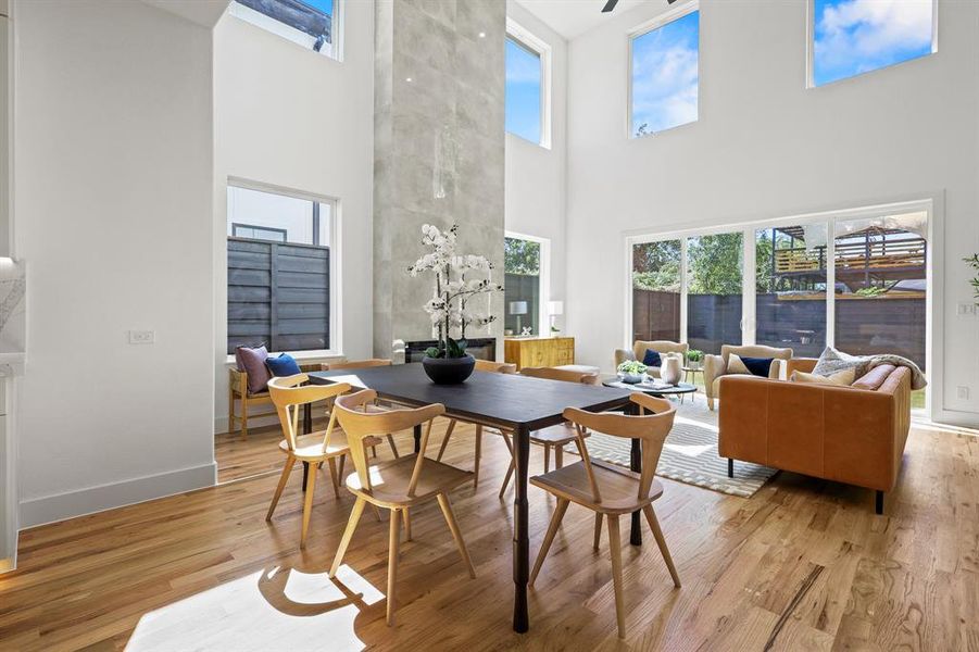 Dining room featuring a high ceiling and light hardwood / wood-style flooring