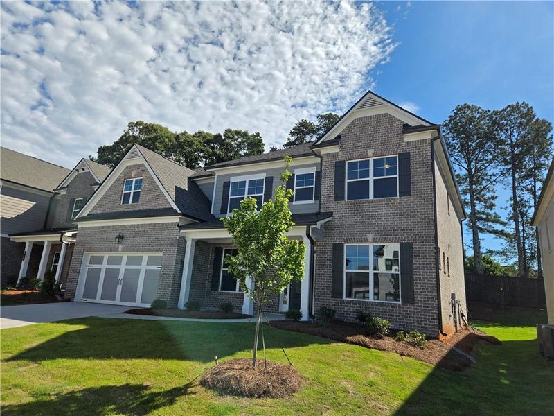 Front exterior of a new home in Pinecrest Ridge, Dacula, GA, highlighting curb appeal (Image 19). Front exterior of a new home in Pinecrest Ridge, Dacula, GA, highlighting curb appeal (Image 19).