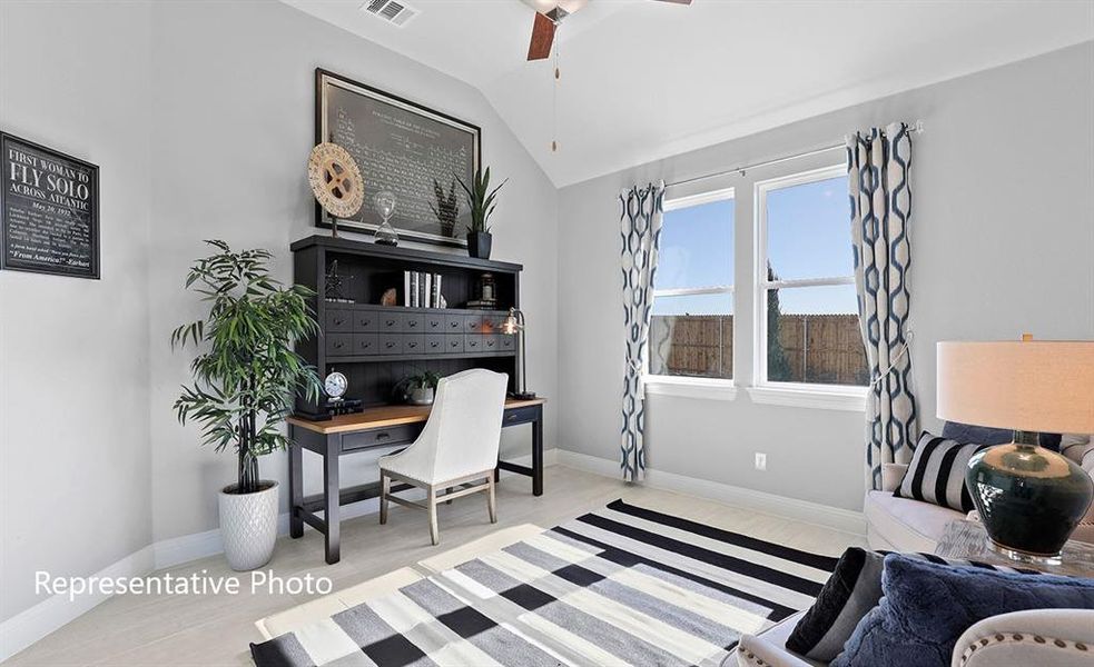 Office area featuring a ceiling fan, lofted ceiling, and wood finished floors