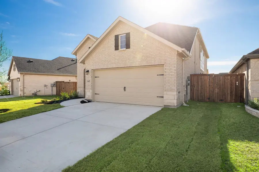 Front exterior of a new home in Reunion, Rhome, TX, highlighting curb appeal (Image 2). Front exterior of a new home in Reunion, Rhome, TX, highlighting curb appeal (Image 2).